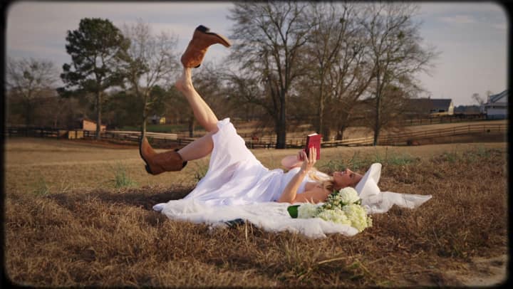 A couple laughing in a winter field during a Charleston-area film shoot